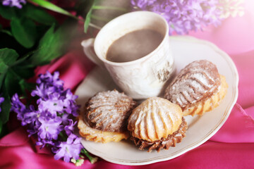 Hot coffee and delicious cookies and romantic flowers