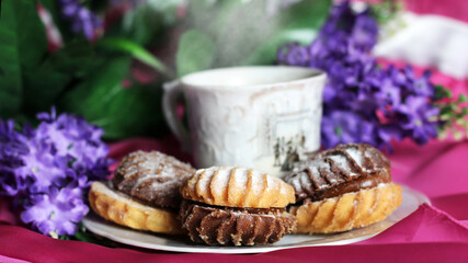 Hot coffee and delicious cookies and flowers, romantic dinner