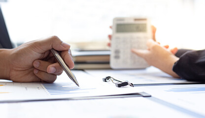 Young business men and women in Asia are brainstorming, analyzing data from graphs in the meeting room.