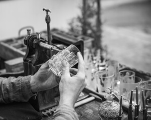 craftsman engraving ornaments on a glass