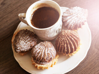 Hot coffee and delicious cookies on wooden background, vintage