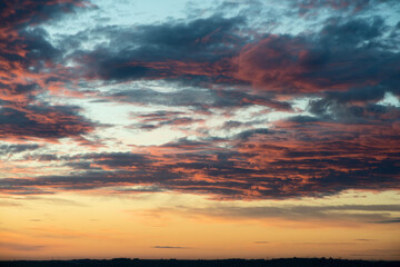 the sky at sunset is orange and red with clouds, the sky is dramatic colors