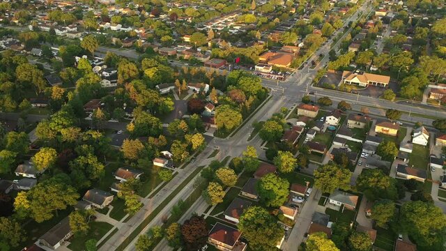 Aerial view of american suburb at summertime.  Establishing shot of american neighborhood. Real estate, top down view of residential houses. Drone shot, from above