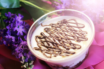Tiramisu desserts in the cup and purple flowers