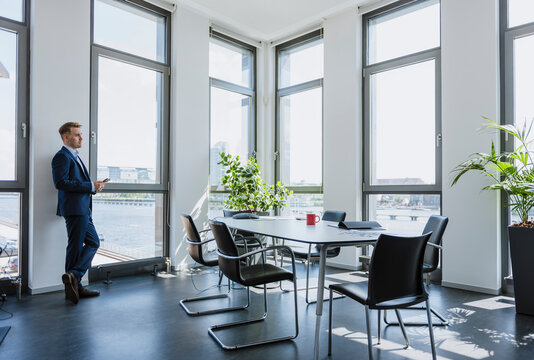 Businessman standing at thw window in office