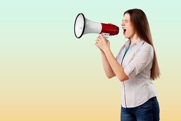 Beautiful woman holding megaphone and screams