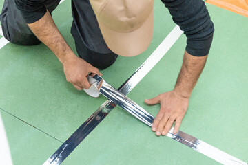 Man working with flooring tape