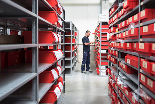 Man in storehouse of a factory scanning goods