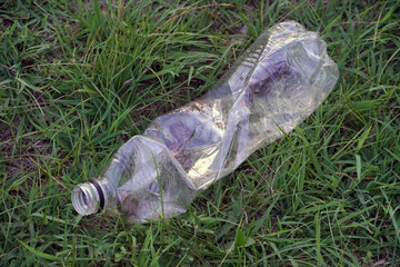 used plastic bottle as garbage on the grass, pollution concept