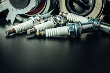 Car spark plugs on black background close up