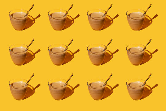 Pattern of vintage cups of latte against yellow background