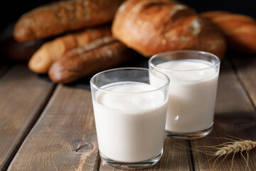 Probiotic cold fermented dairy drink kefir on wooden background.