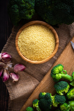 Bowl of couscous, garlic and fresh broccoli