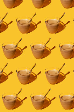 Pattern of vintage cups of latte against yellow background