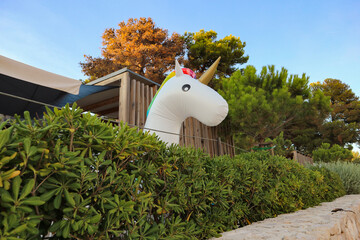 Pakostane/Croatia-July,17th,2017: Bungalow on the sea shore with floating beach unicorn set to look...
