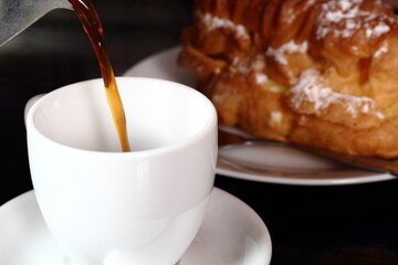 Pouring coffee from moka pot into cup