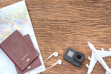 Passport with a map on old wooden background.Travel planning.Top view of traveler accessories with a camera, plane on world map.Preparation for travel.Traveling Journey Vacation Holiday concept.