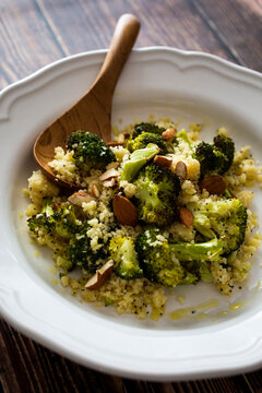 Plate of ready-to-eat couscous with broccoli, garlic and almonds