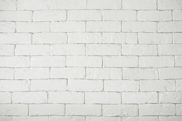 A white brick wall. Crookedly laid bricks