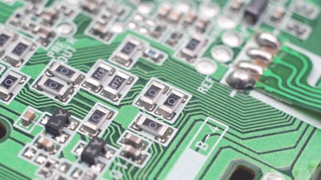 Green circuit board background of PC computer motherboard. Computer circuit board close up, electronic technology background