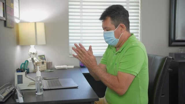 474 Office employee using hand sanitizer during COVID pandemic