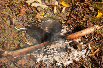 steel cup with cofee on fire cooking