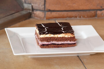 Layer cake with fruit and cream fillings decorated chocolate icing