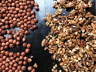Roasted hazelnuts and walnuts on a baking sheet