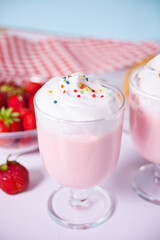 strawberry smoothie milk shake cocktail with whipped cream.