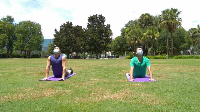 479 Two people doing yoga while wearing a mask during the Covid19 pandemic