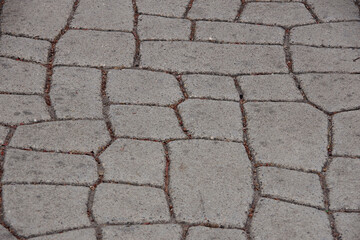 Close-up high angle view of a concrete street pavement with a stone-like stamped pattern