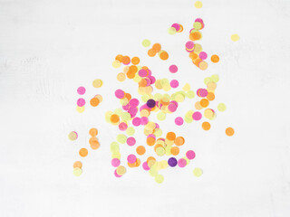 Colorful paper confetti scattered on a white background