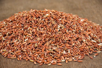 off white brown rice on wooden surface