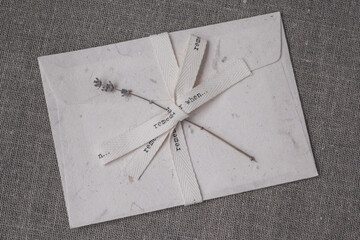 Vintage envelope with beige ribbon. Eco-friendly handmade paper. Sprig of lavender.