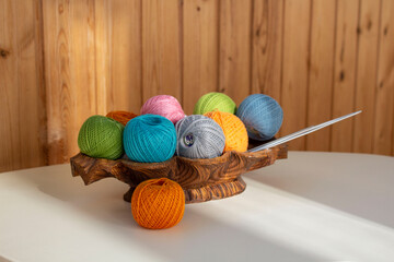 Colorful balls of thread with needles for knitting