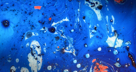 Closeup abstract color mixing of water, acrylic,oil and milk for use as background image. Acrylic texture with beautiful pattern, multi color background photo.

