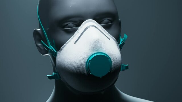 Respirator mask with teal valve on rotating grey mannequin head