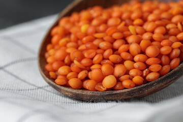 Wooden spoon with red lentils close up