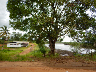 Fototapeta premium West Africa, Liberia, Yekepa, 4 of July 2015. View on lake in the bush. Beautiful house for living for expatriate workers. Good conditions provided for foreign specialists in mining business.