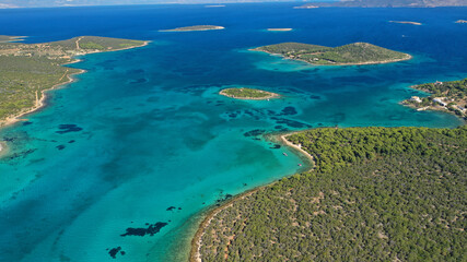 Aerial drone photo of beautiful paradise island complex in gulf of Petalion that form a blue lagoon in South Evia island near Marmari, Greece