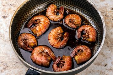 fried shrimp in a pan in the home kitchen. Grilling food in a pan. Fish delicacy.