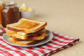 Slice of fresh bread with butter and jam on table