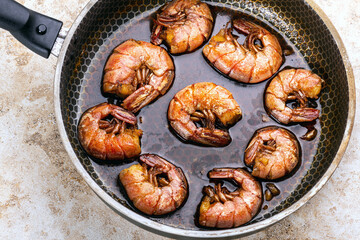 fried shrimp in a pan in the home kitchen. Grilling food in a pan. Fish delicacy.