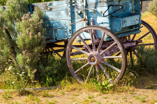 A vintage freight wagon with wooden spoked wheels and surrounded by sage brush near The Dalles, Oregon.