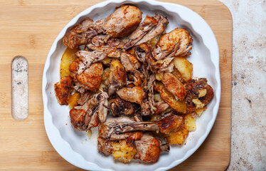 baked chicken legs with potato. Homemade freshly baked food. Crispy chicken with baked potatoes.