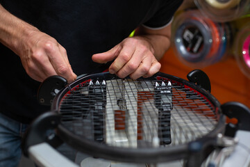 Process of stringing a tennis racket in a tennis shop, sport and leisure concept