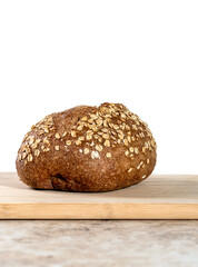 freshly baked bread and soup. Warm homemade freshly cooked lunch. Whole grain loaf and knife on the board