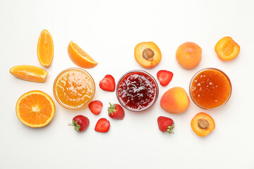 Composition with jam and ingredients on white background, top view