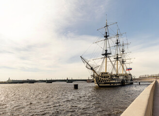 Fototapeta na wymiar An old sailing frigate on the Neva river in Saint Petersburg, Russia. An old ship is parked on the embankment of the Neva river.