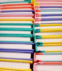 multicolored note books over the white background